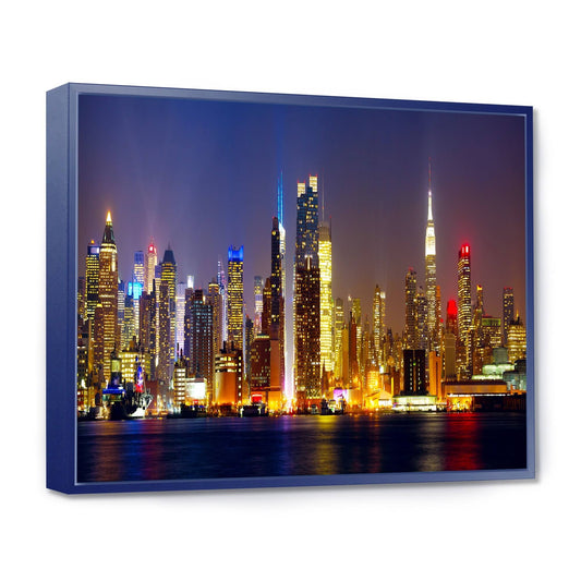 Designart &New York Skyline at Night& Cityscape Photo Framed Canvas Print - 32 in. Wide x 16 in. High - Blue KLF9_T8XDR07